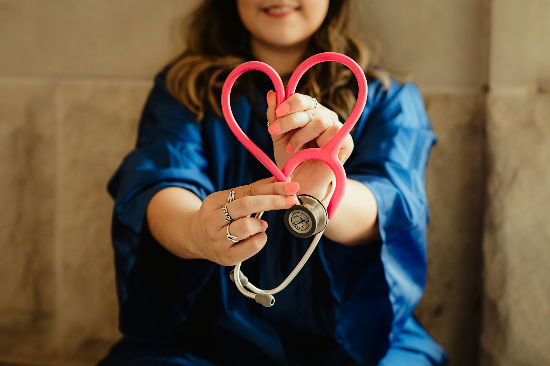 GP holding a stethoscope in shape of a heart